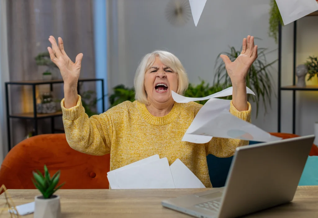 Image of frustrated woman with paperwork flying
