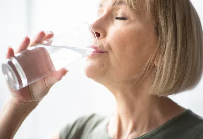Image of a woman drinking a glass of water