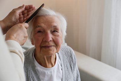 Image of resident getting hair combed